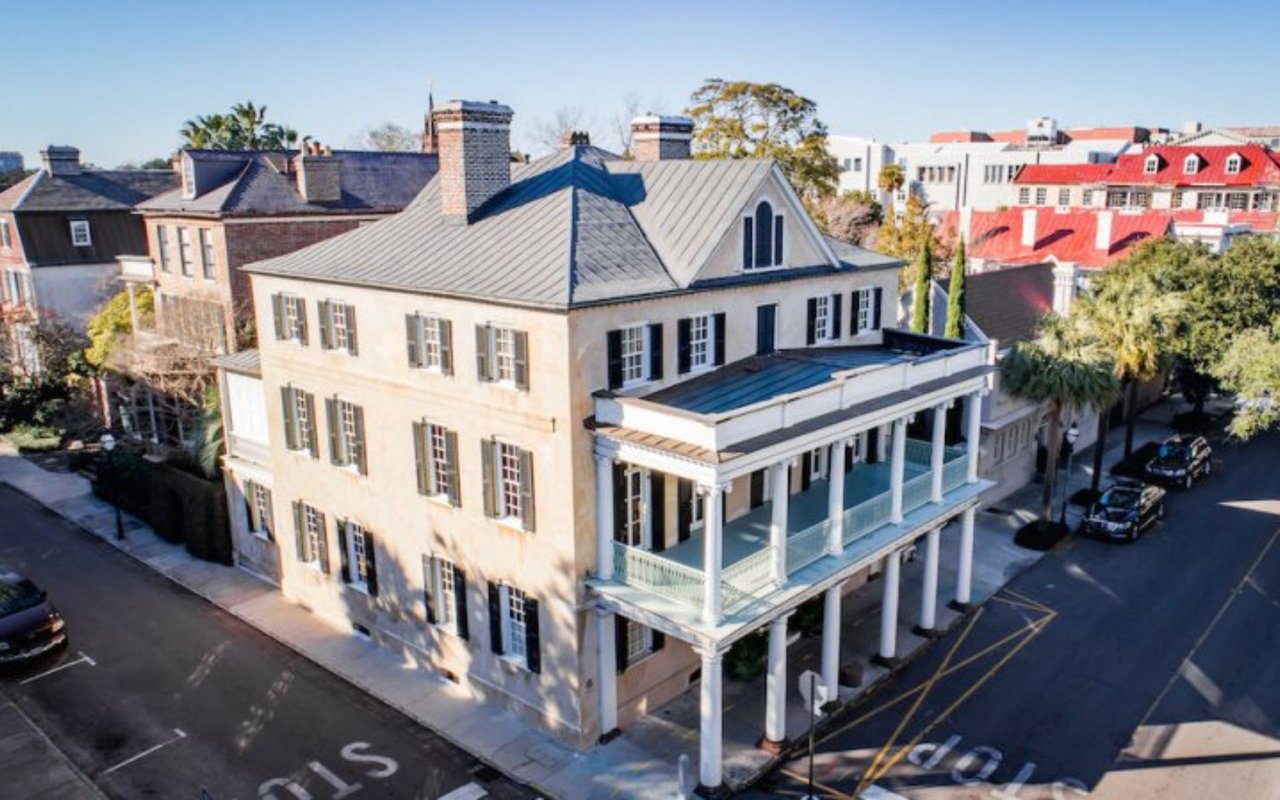 Branford-Horry House with a gray metal roof and a two-story columned wraparound porch.