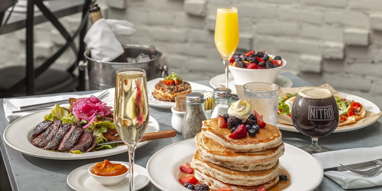 Brunch spread with pancakes, fresh fruit, coffee and mimosas at Oxford Exchange in Tampa Florida