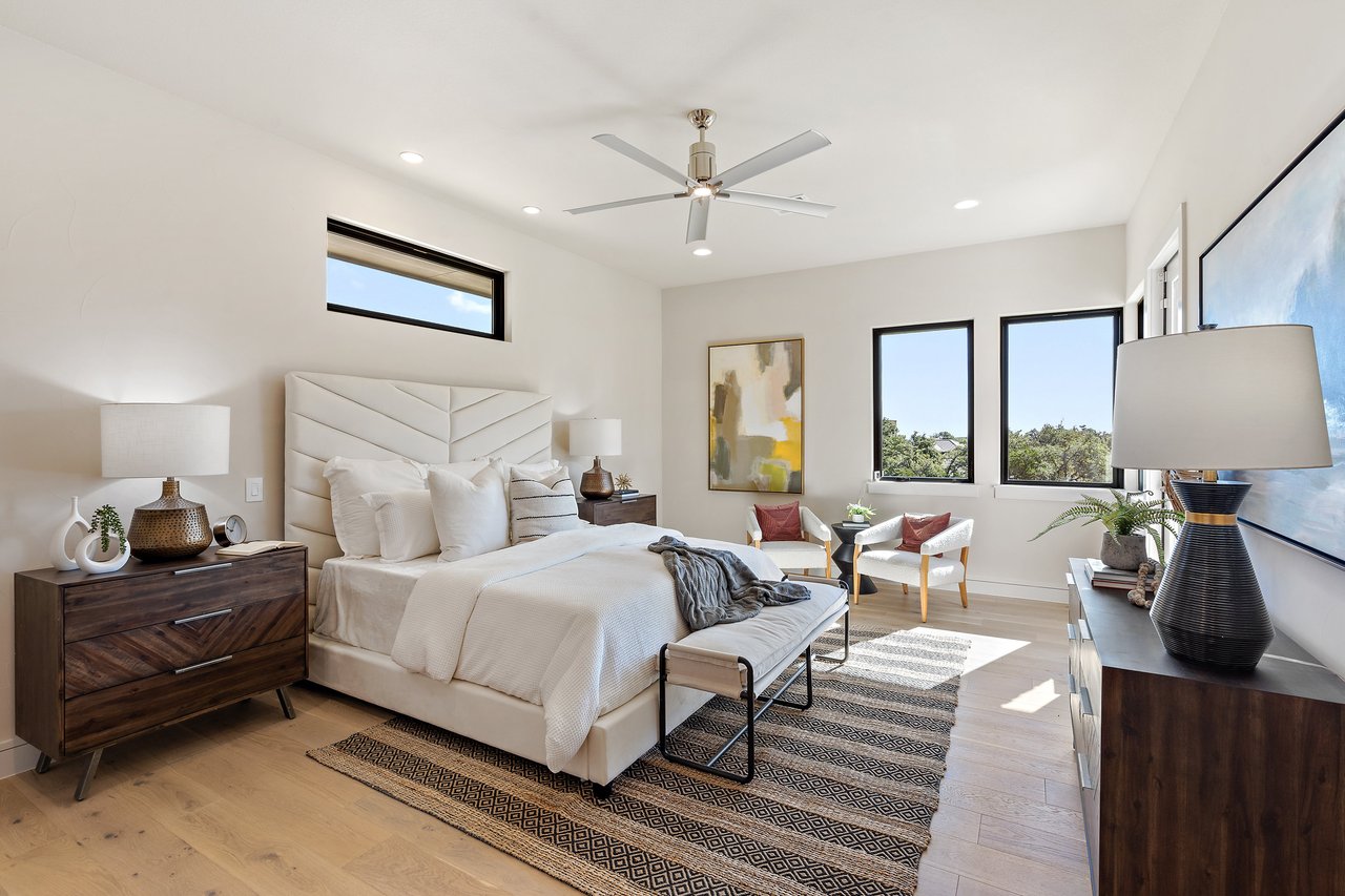 Guest bedroom with ceiling fan and natural light at this Caudill Lane home in the Bee Caves area of Austin, Texas.