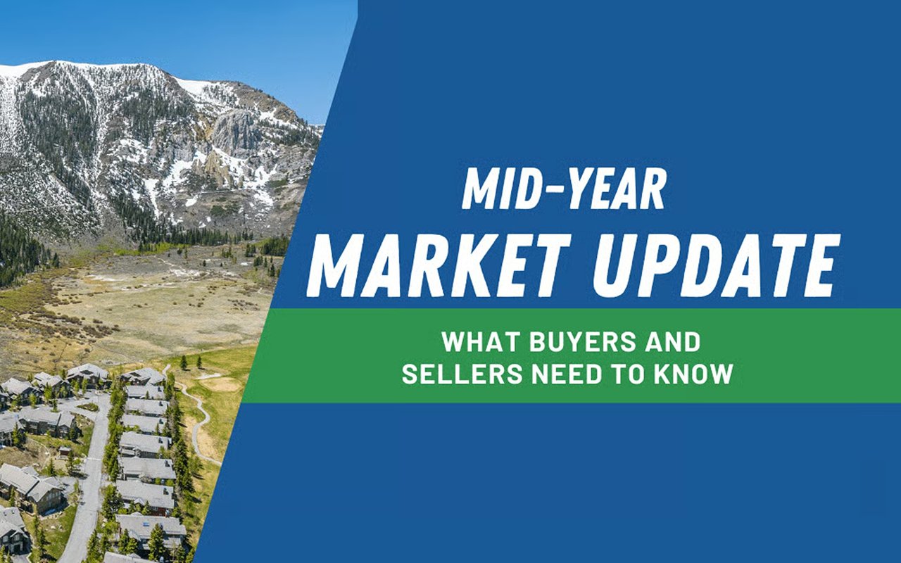 Mid-year market update: what buyers and sellers need to know, over a mountain valley with homes.