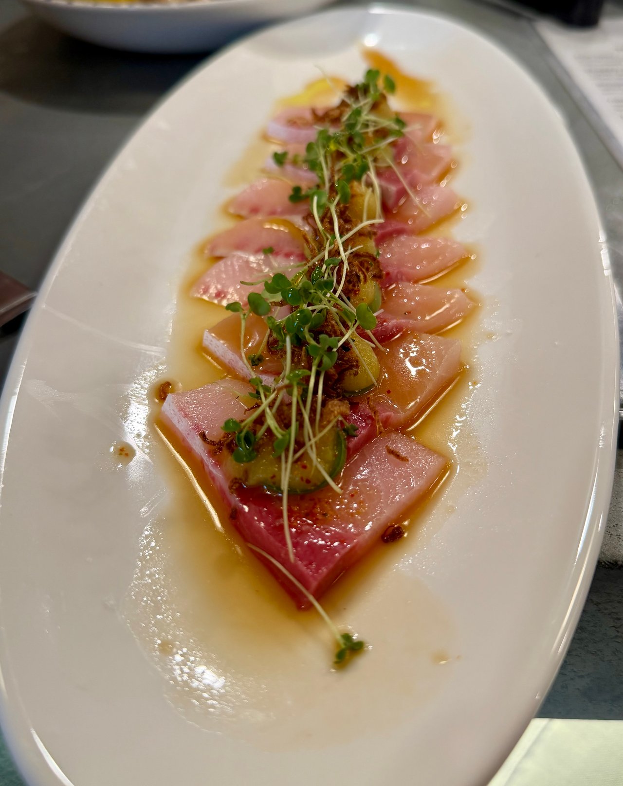 Fresh Hamachi Crudo with pineapple puree, Serrano, crispy shallots, citrus soy, evoo