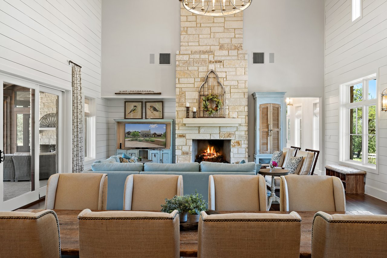 Great room and dining area at 335 Winning Colors with a stone fireplace and long dining table for entertaining.