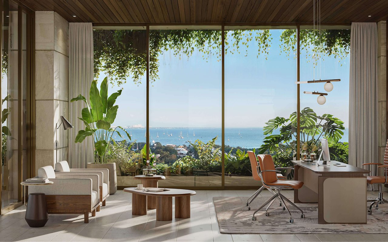 Furnished office with floor-to-ceiling windows overlooking the water and boats.