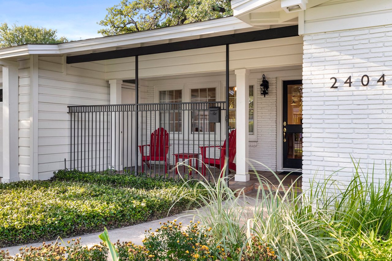 Covered front porch with red chairs, address number visible, 2404 Westover Rd.