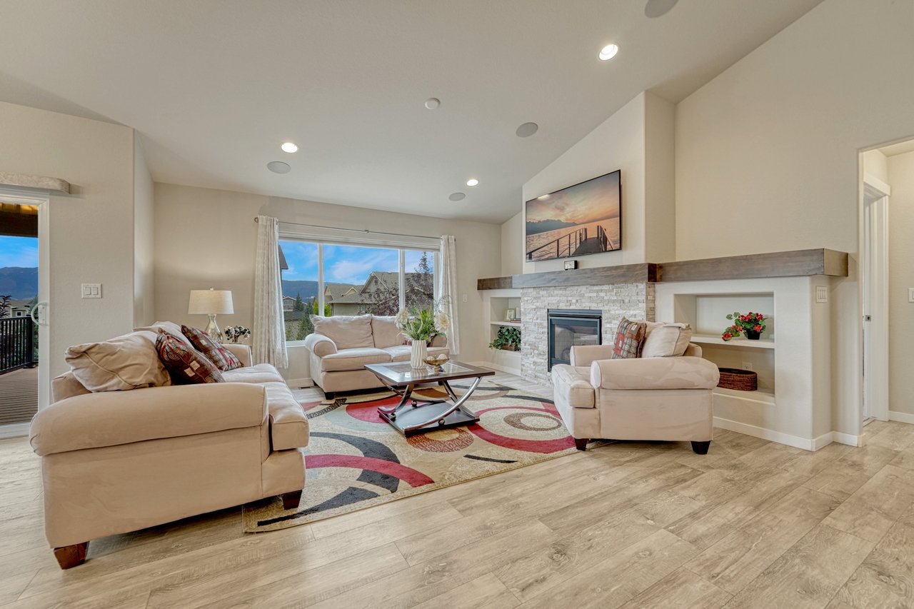 Living room seating area facing the stone fireplace