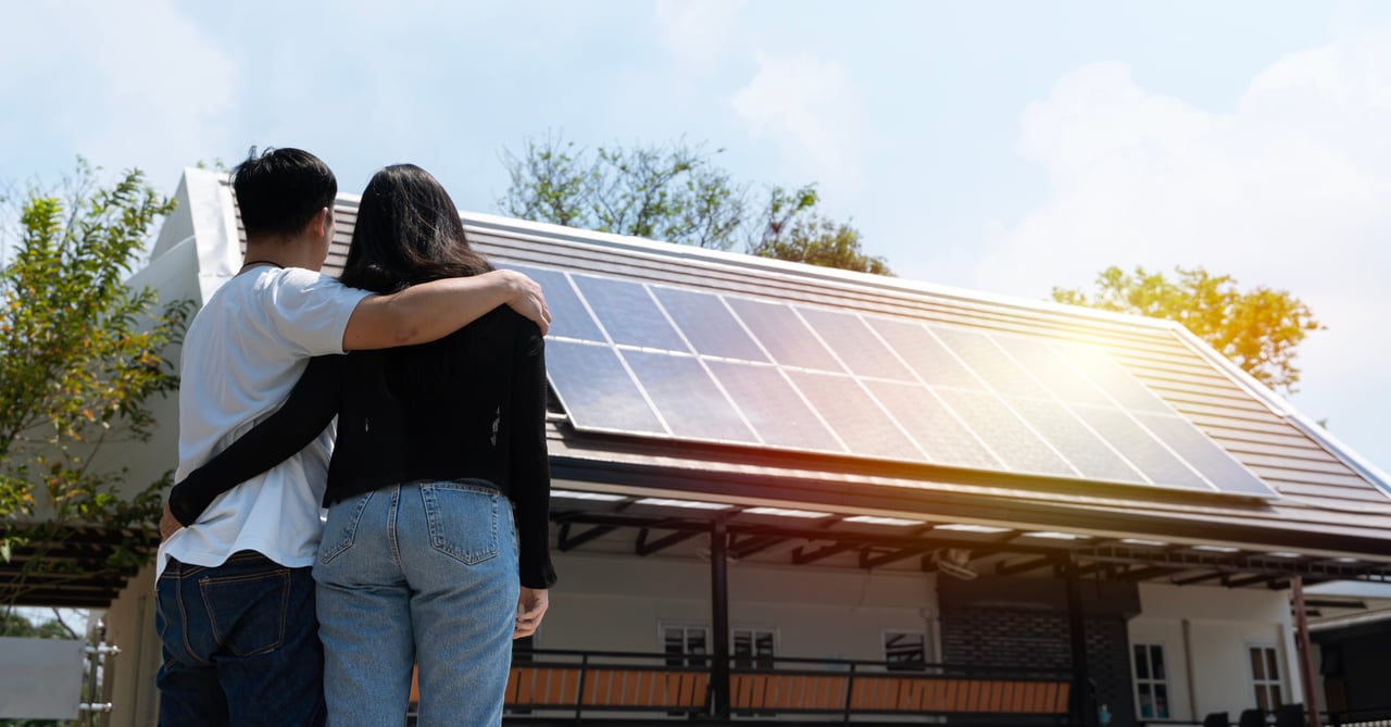 Home buyers touring a home with solar panels in the western Chicago suburbs