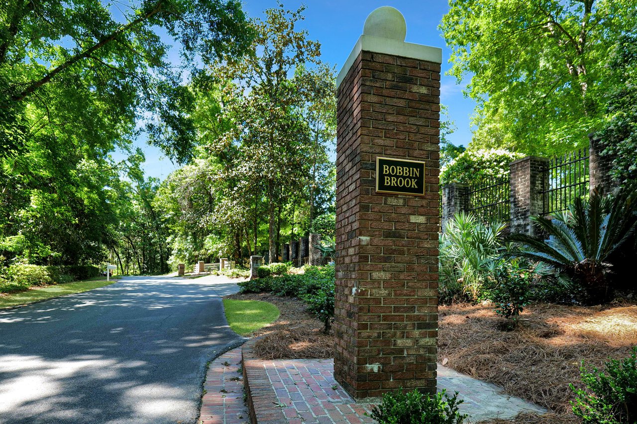 A ground-level view of the entrance sign for "Bobbin Brook," indicating the name of the residential community.