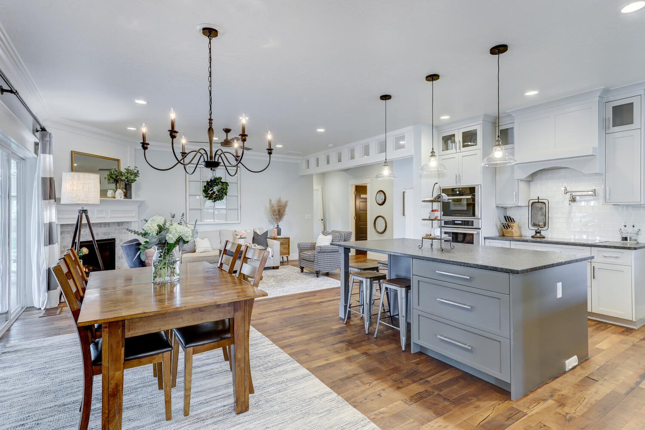  An expansive open-concept living space featuring a dining area, kitchen, and living room.