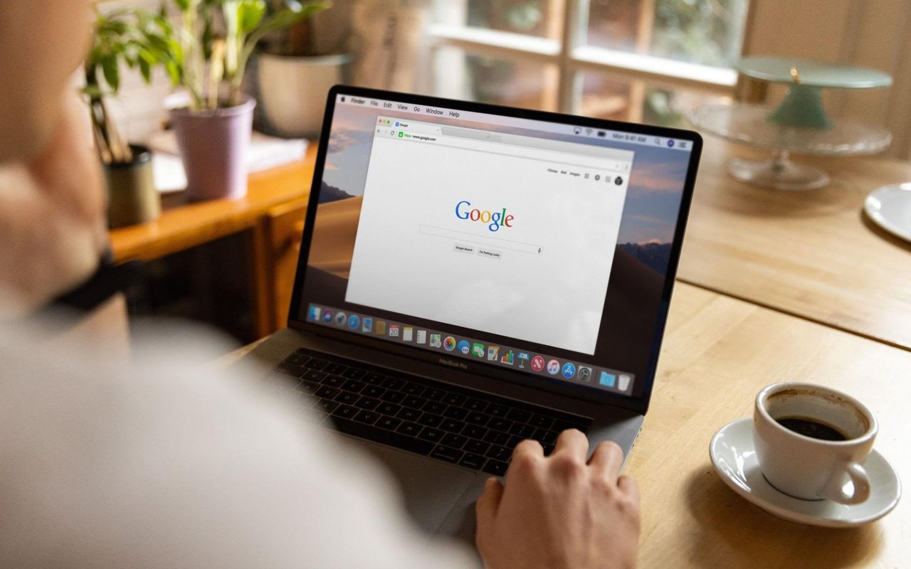 A man using a search engine on his laptop to find information online.