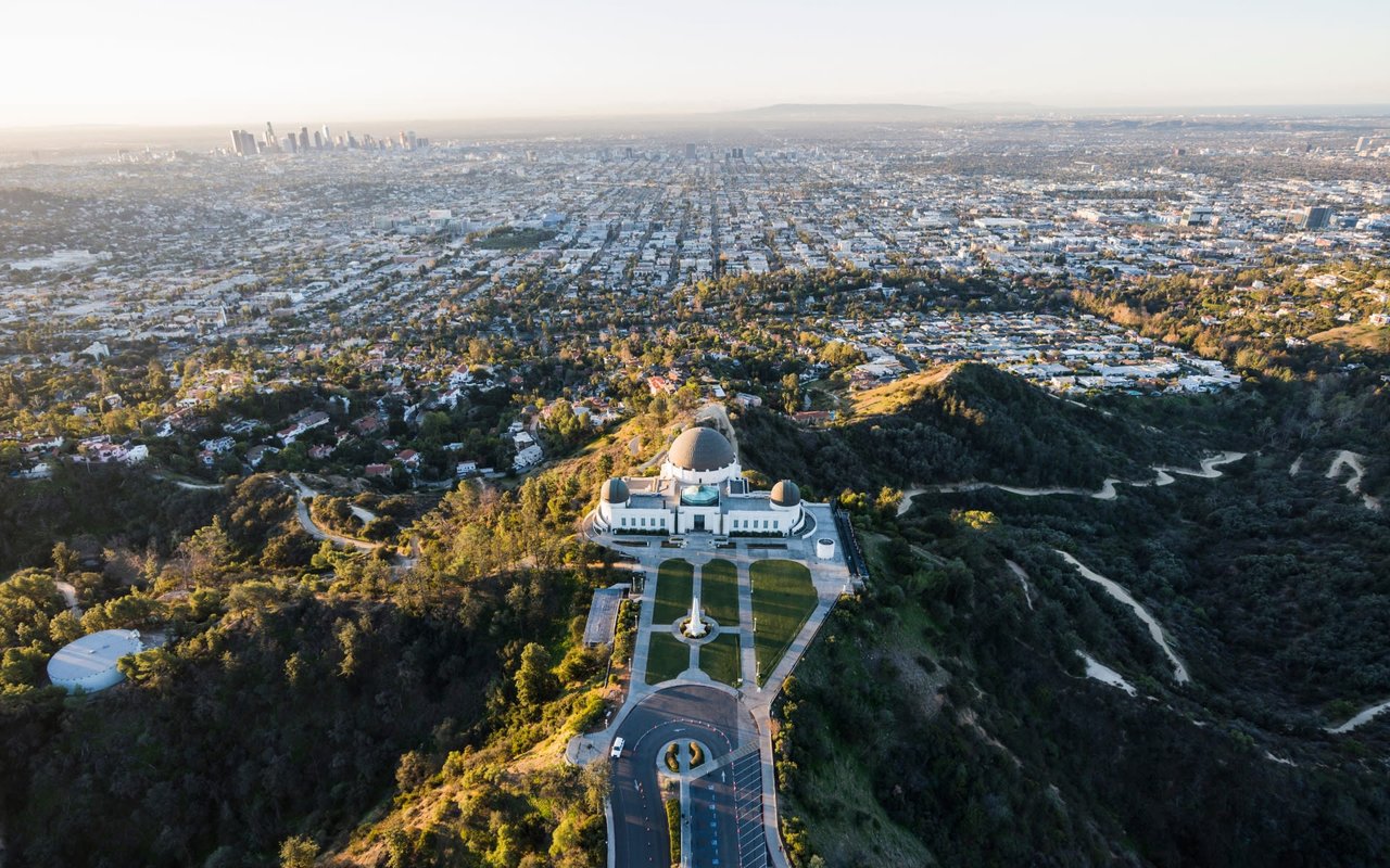 An aerial view of the city of Los Angeles with a large white dome on top of a hill