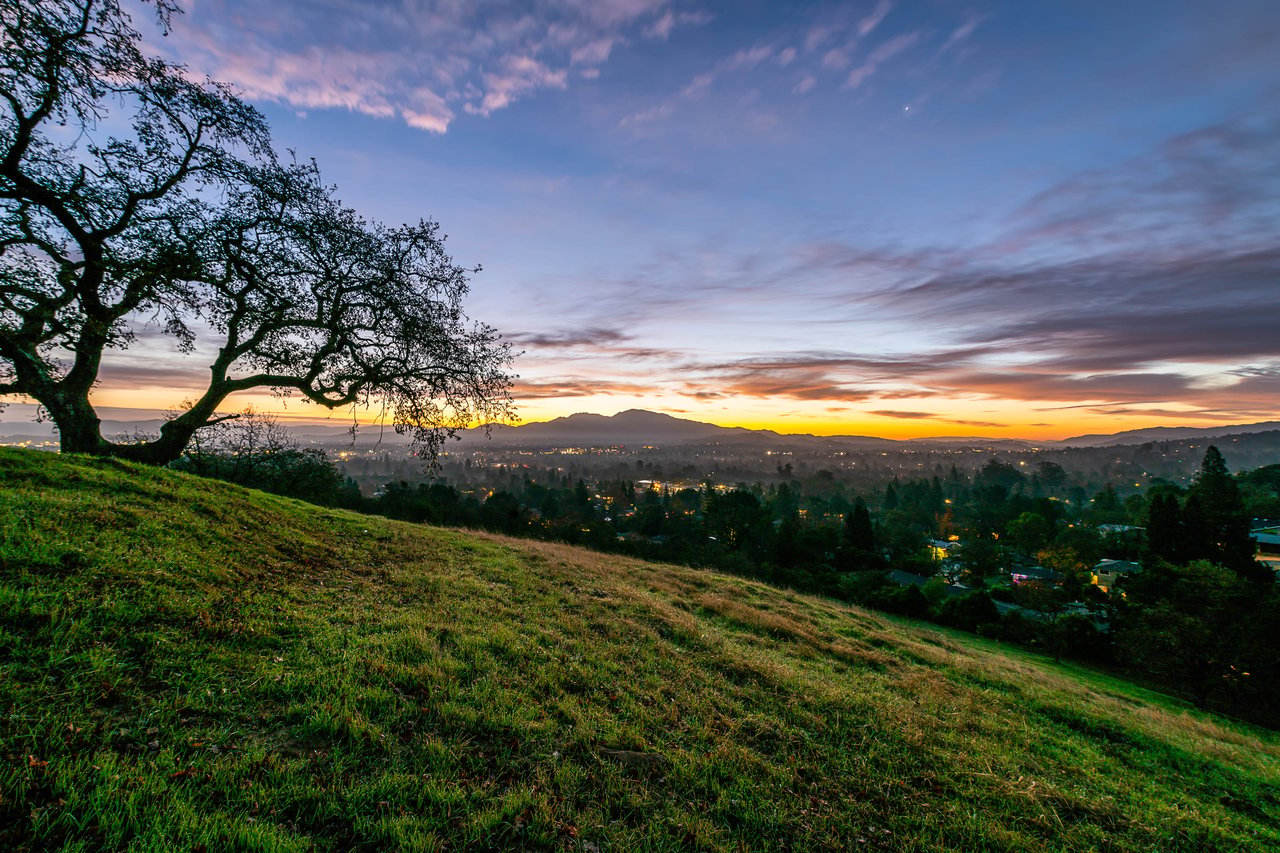 A picturesque sunset over a rolling hilltop