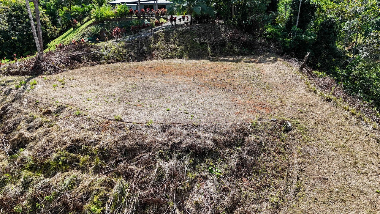 An elevated 1.2 acres lot with two plantels, panoramic mountain and jungle views.