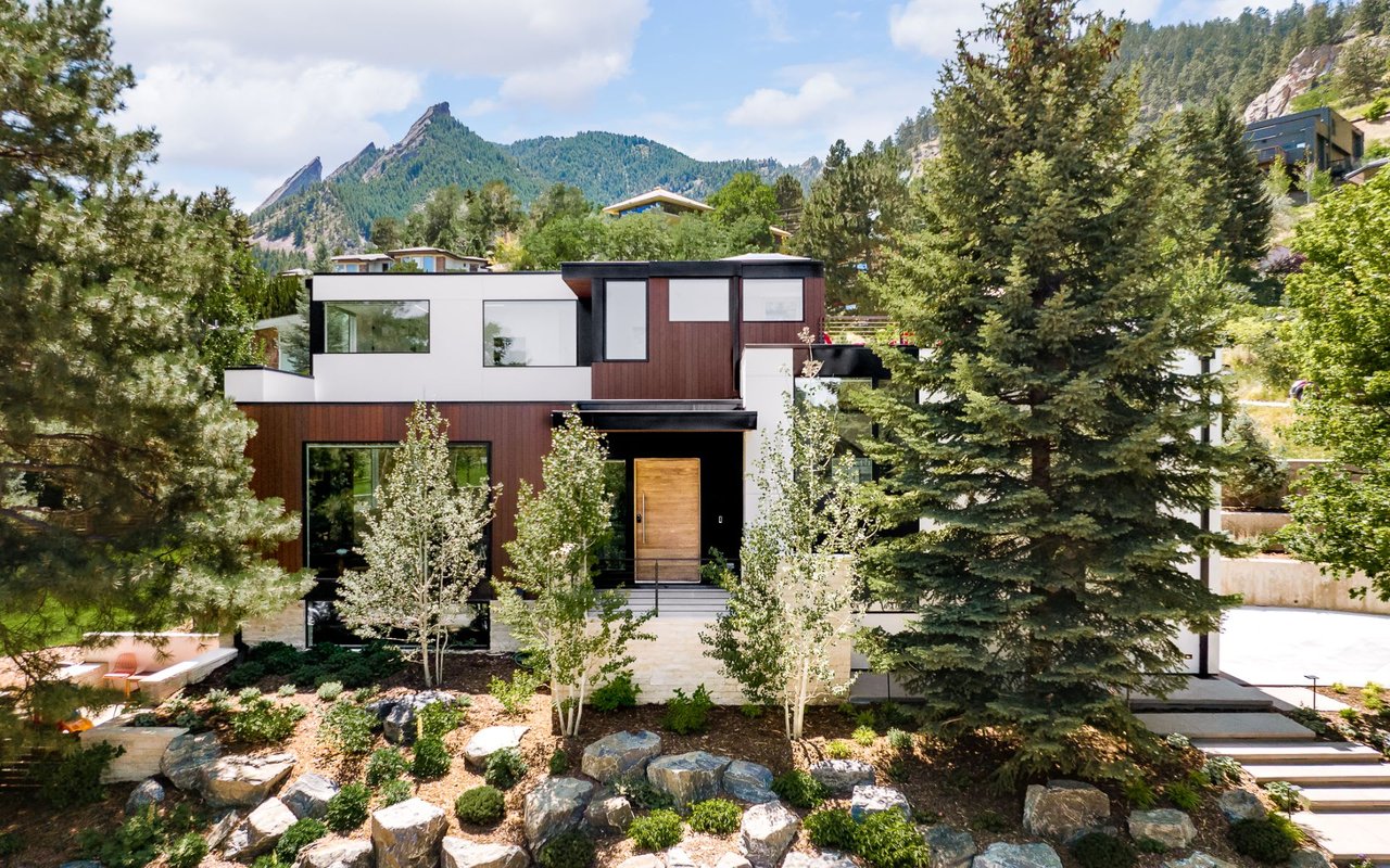 Modern single family home among trees located at the base of the foothills in Chautauqua Boulder Colorado