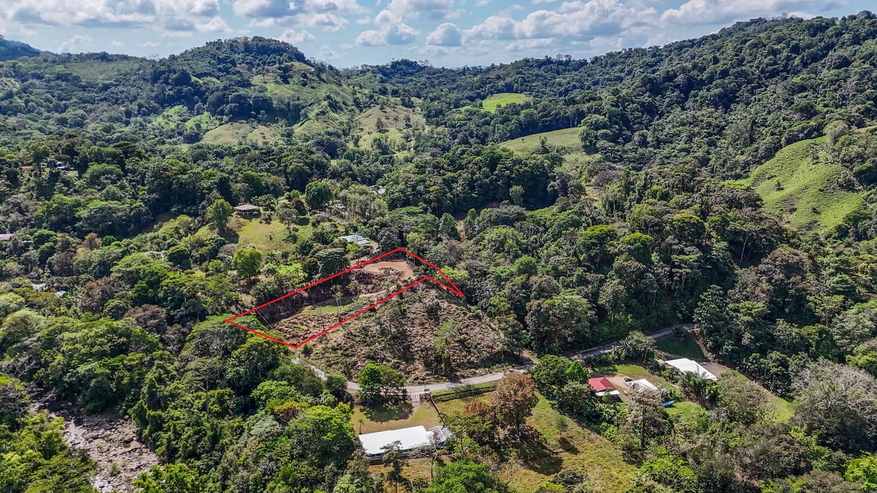 An elevated 1.2 acres lot with two plantels, panoramic mountain and jungle views.