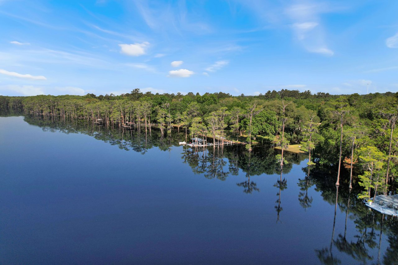 Another aerial view of the lake bradford, showing the expanse of water surrounded by dense forest. The scene is serene and untouched by urban development.