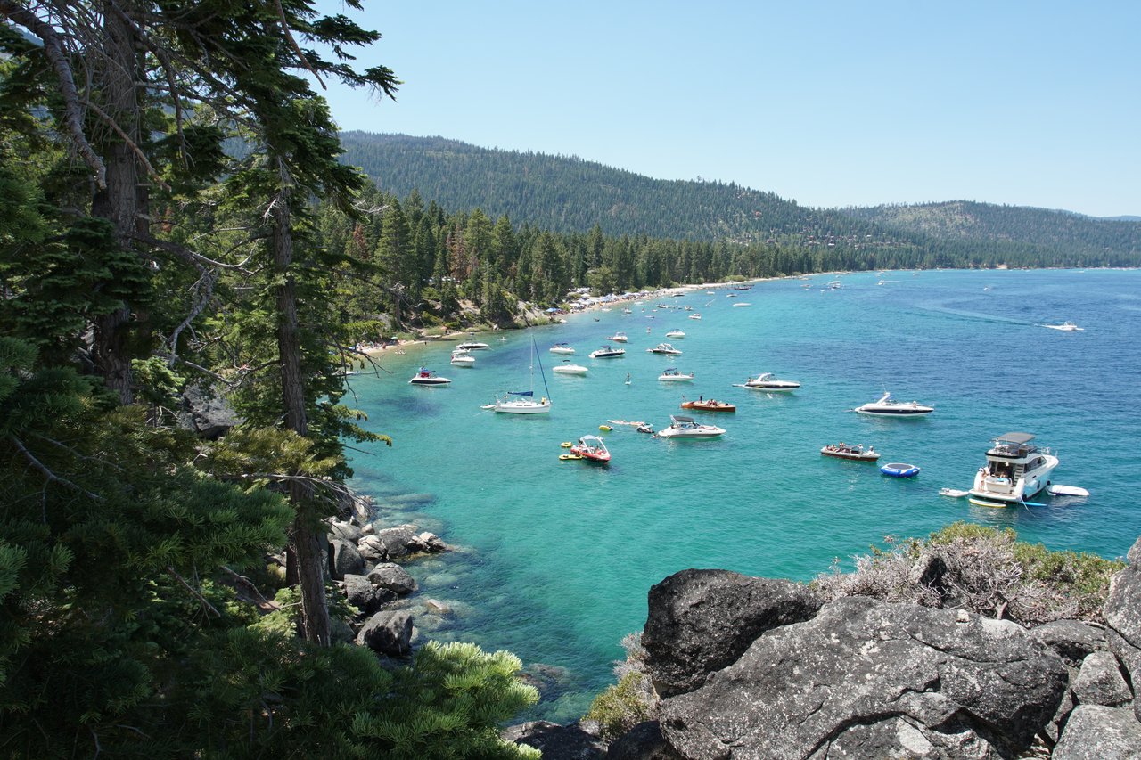 Aerial view of Lake Tahoe homes near the water with mountains in the background – Lake Tahoe real estate lifestyle