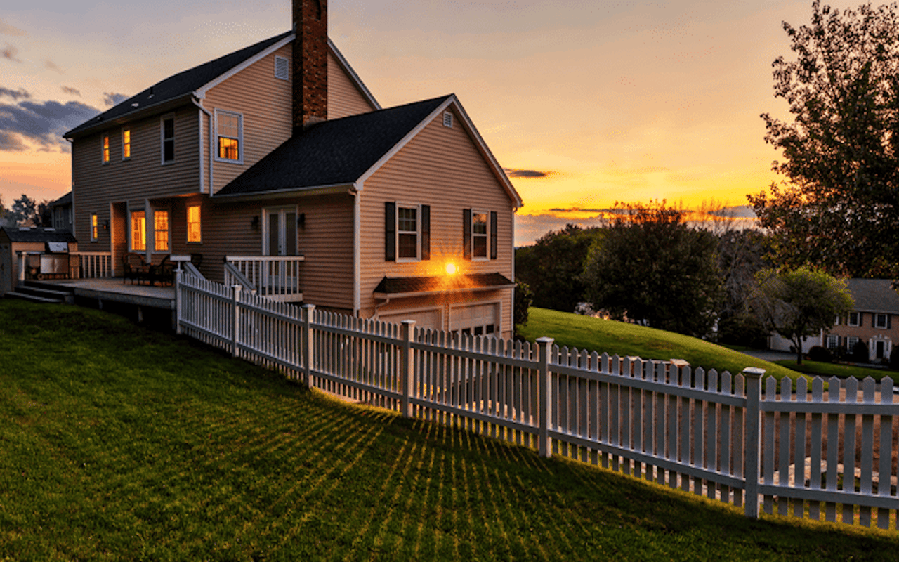 A house with a yard and a picket fence