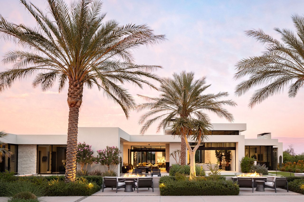 Modern luxury home in Paradise Valley with resort-style backyard, pool, fire feature, and contemporary architecture at sunset.