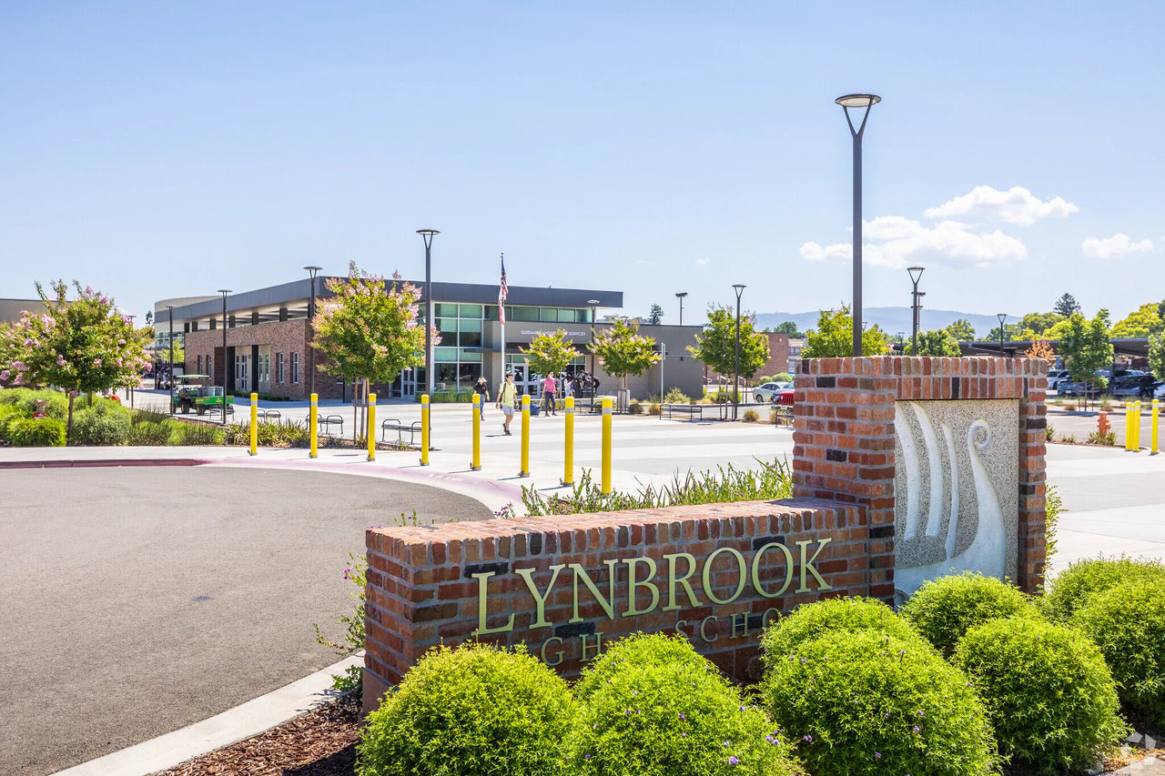 Lynbrook High School entrance sign in front of the campus buildings and landscaped grounds.