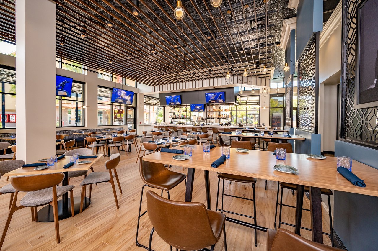 This image shows the stylish interior of Spurrier's Gridiron Grille, a popular spot near Gainesville FL real estate.