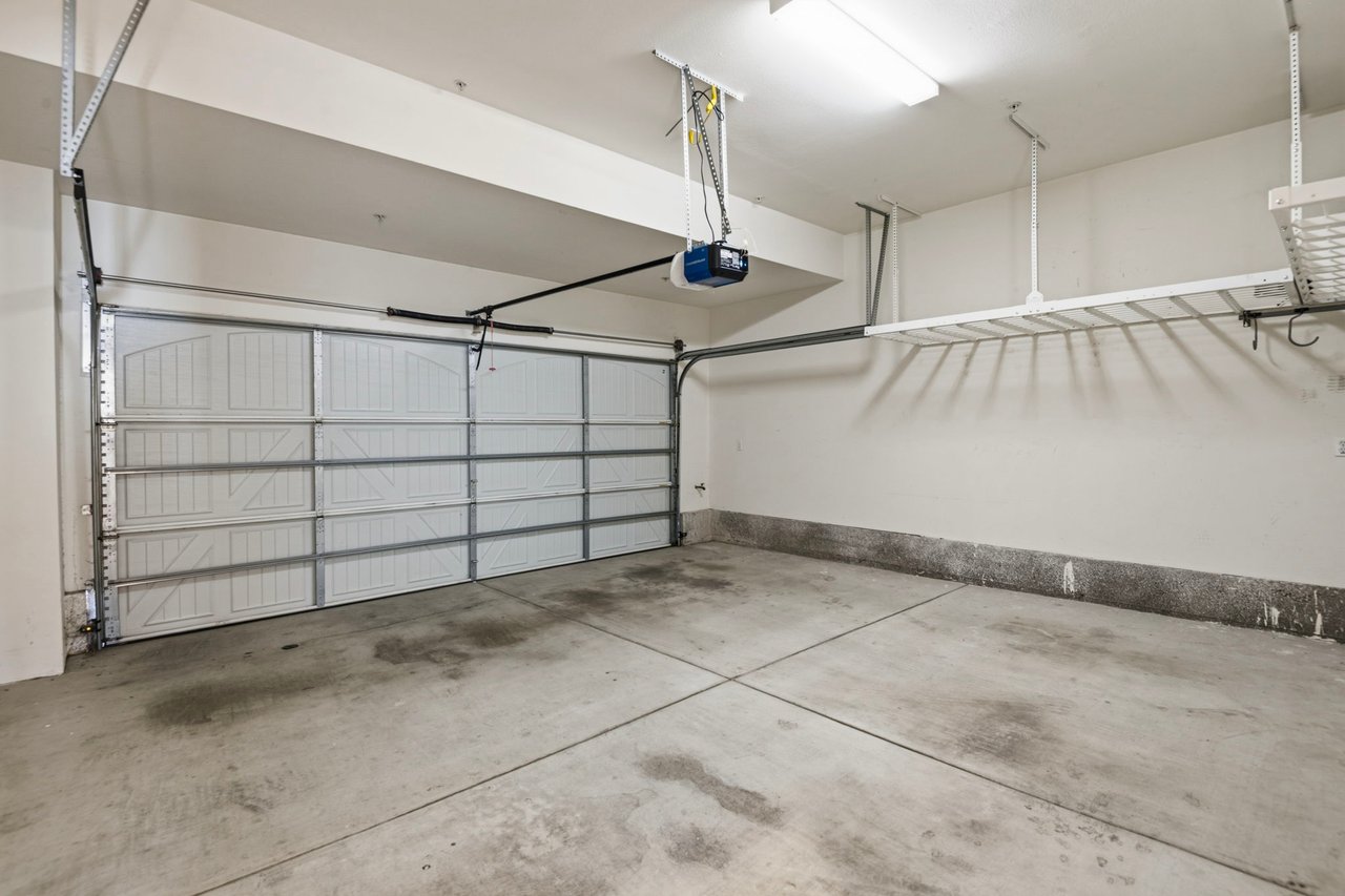 Attached two-car garage interior with automatic garage door opener and direct unit access