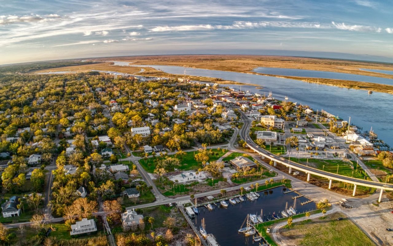 Aerial view of Apalachicola, with its waterfront marina, river and coastal wetlands.