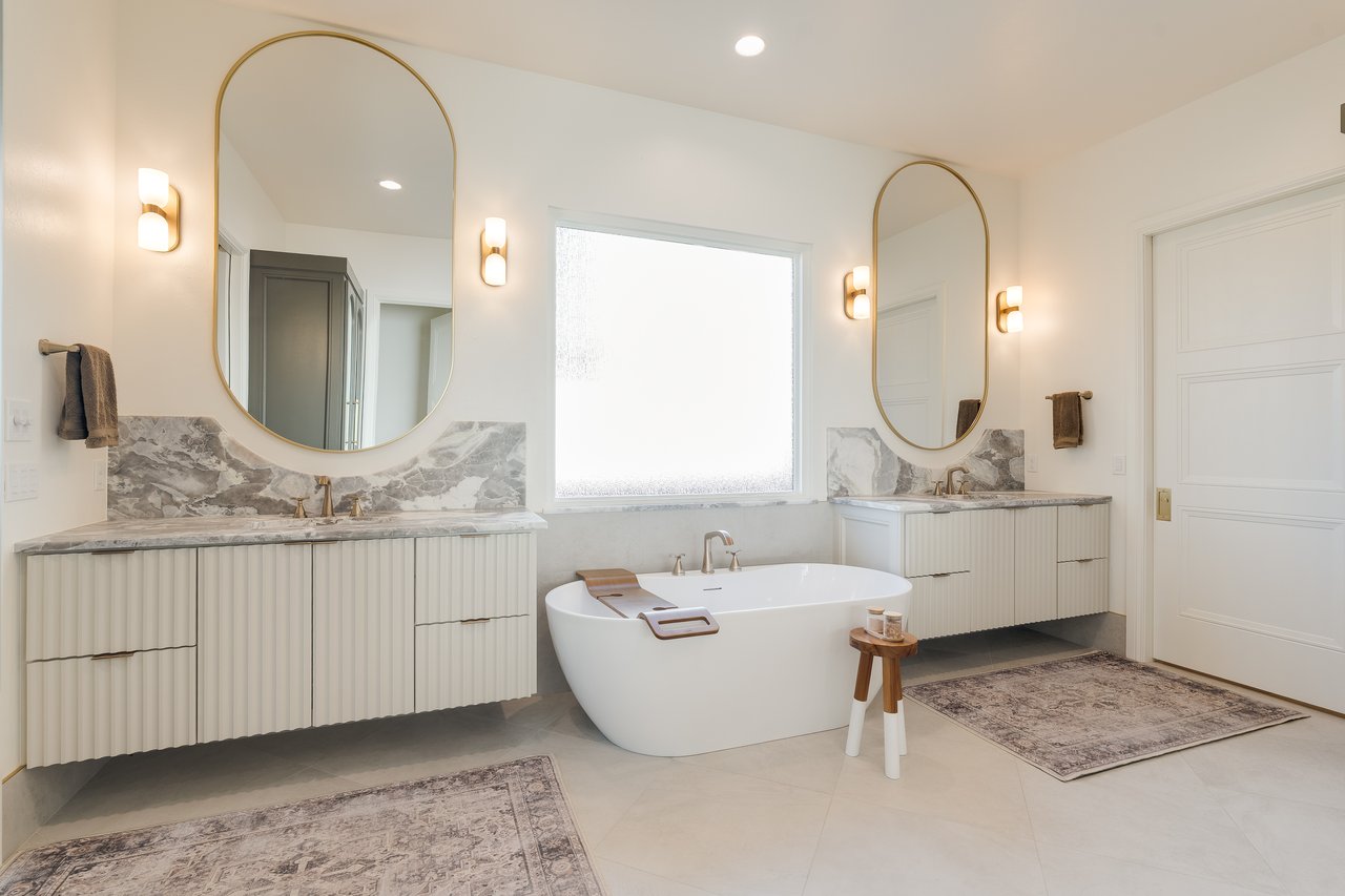 Elegant primary suite in a luxury Oklahoma City home, styled for winter with layered textures and warm neutral tones.