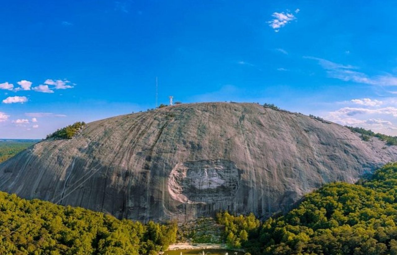 Stone Mountain’s granite dome and carved rock face rise above the surrounding forest.