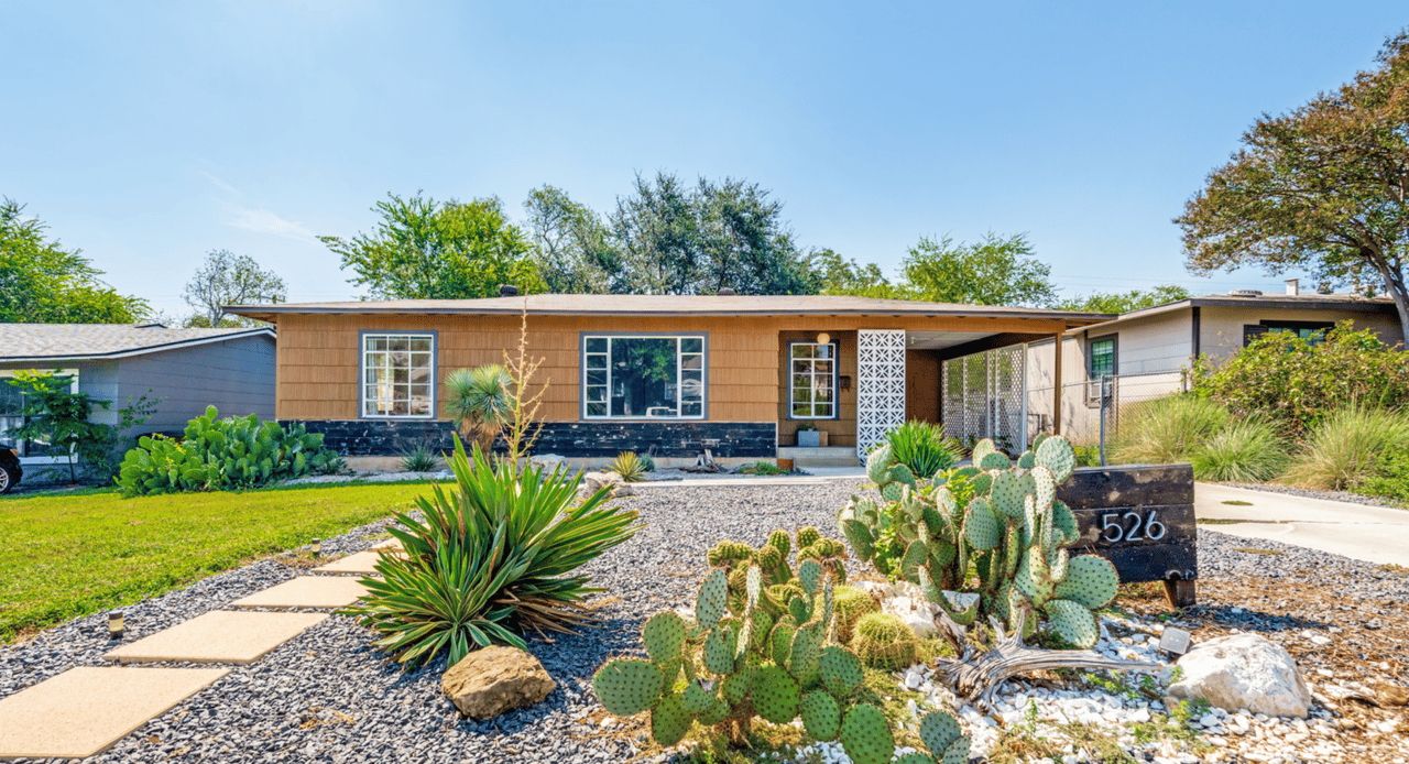 Front exterior of 526 Sumner Dr, a mid-century home in San Antonio 78209 with cactus landscaping and covered carport.