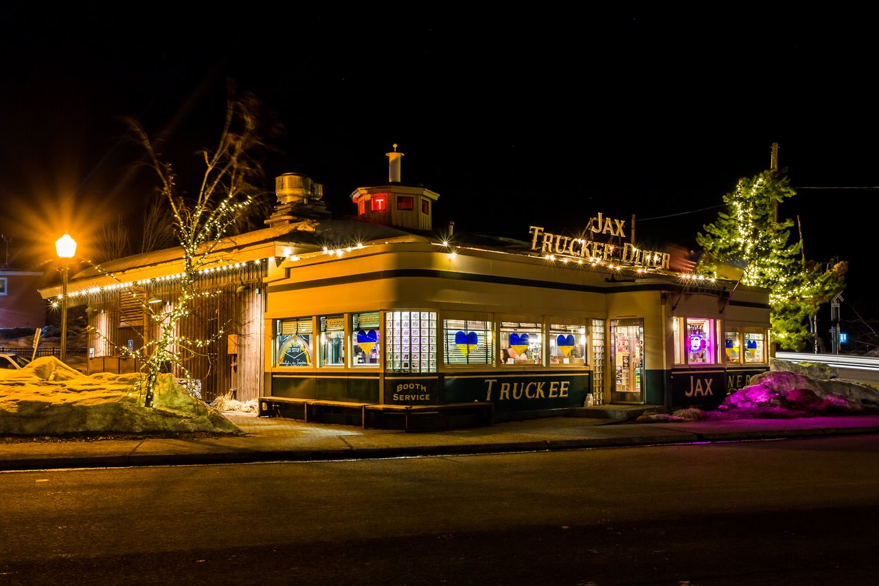 Nighttime view of downtown Truckee with restaurants, lights, and people enjoying the local dining scene.
