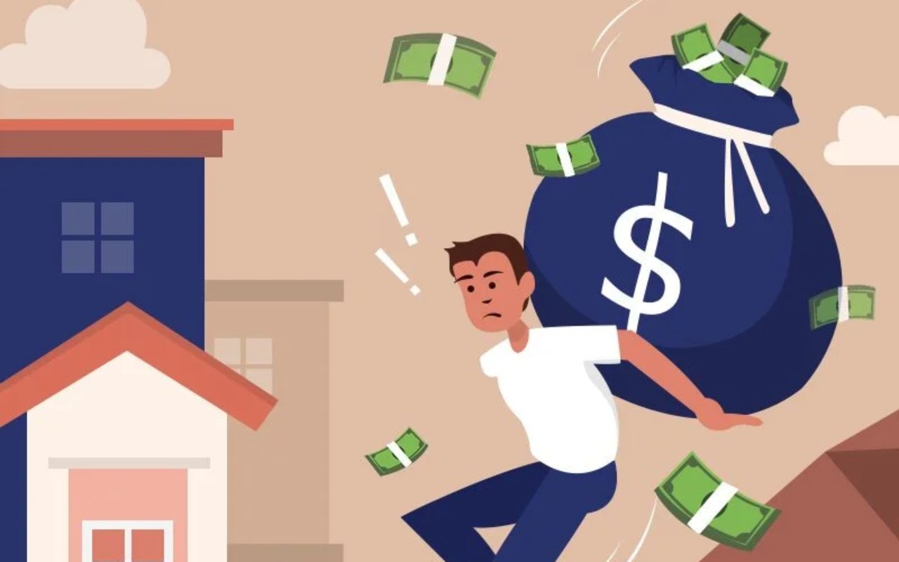 Worried home buyer runs with a large money bag as dollar bills fly around houses.