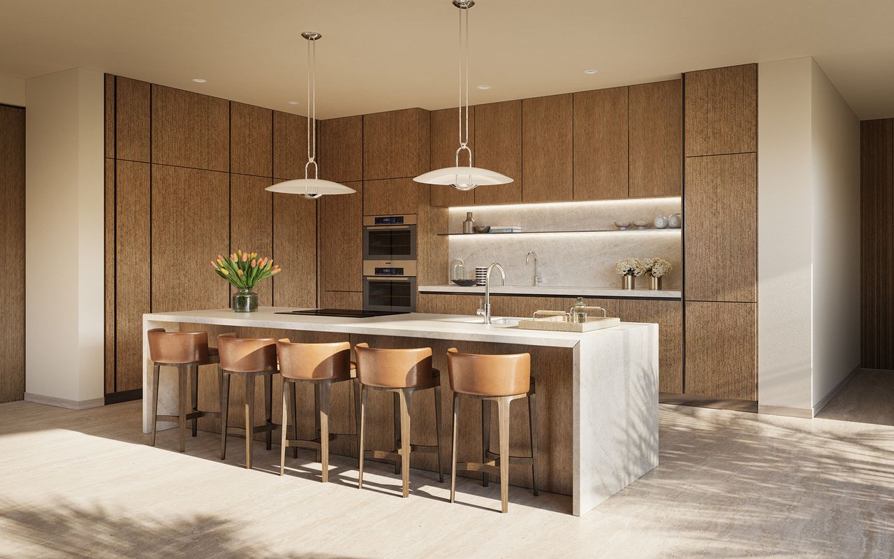 Modern kitchen with wood cabinetry, a white stone island, and leather bar stools.