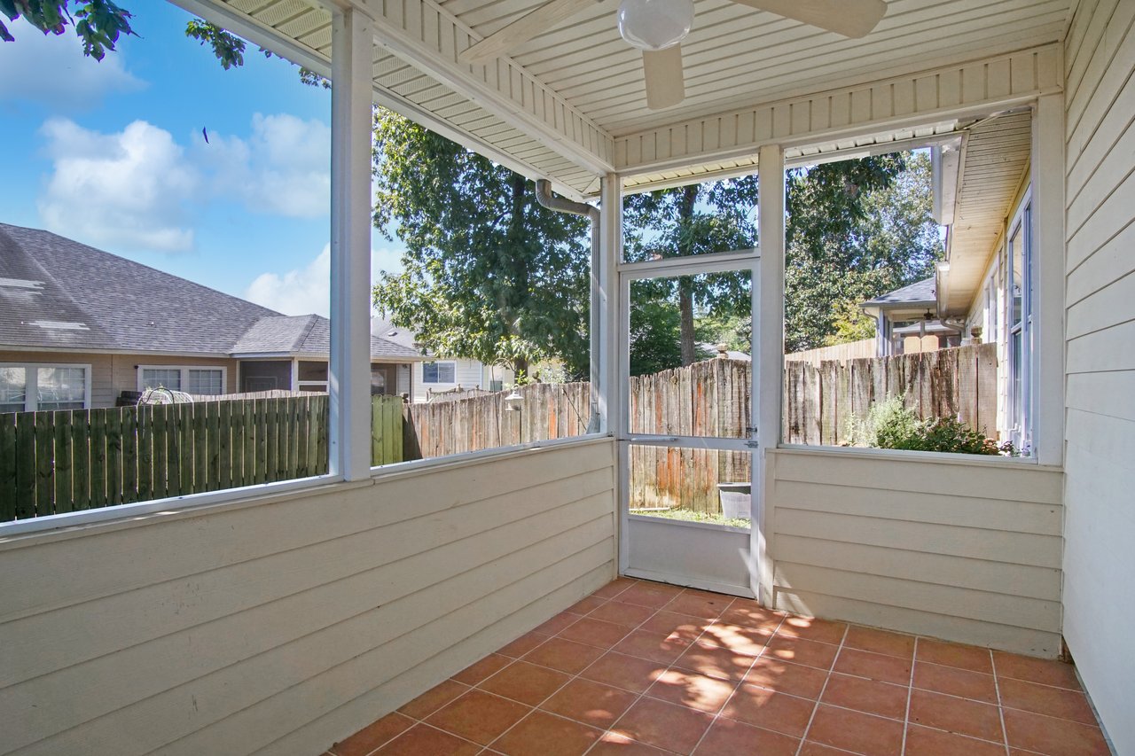 Screened lanai at 5441 Hampton Hill Circle, Tallahassee, Florida 32311 with tile floor, ceiling fan, and fenced backyard view.
