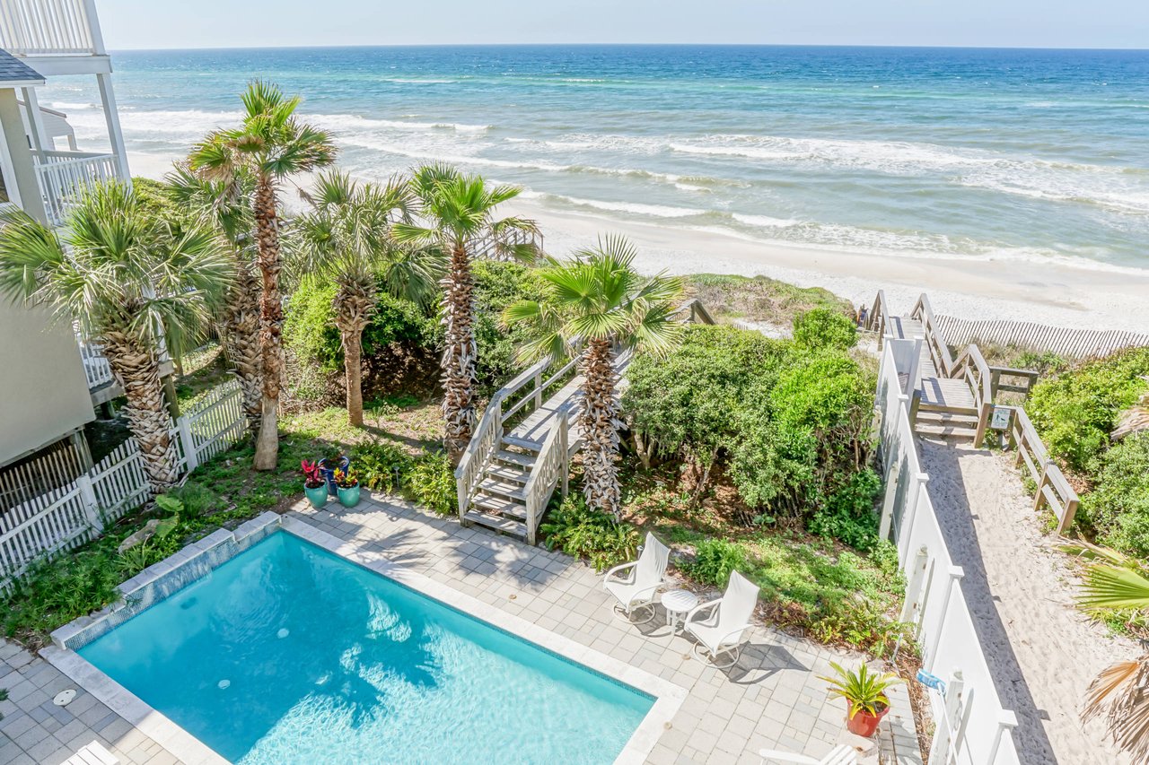 Seaside beachfront home with a pool in the backyard and a boardwalk to the ocen