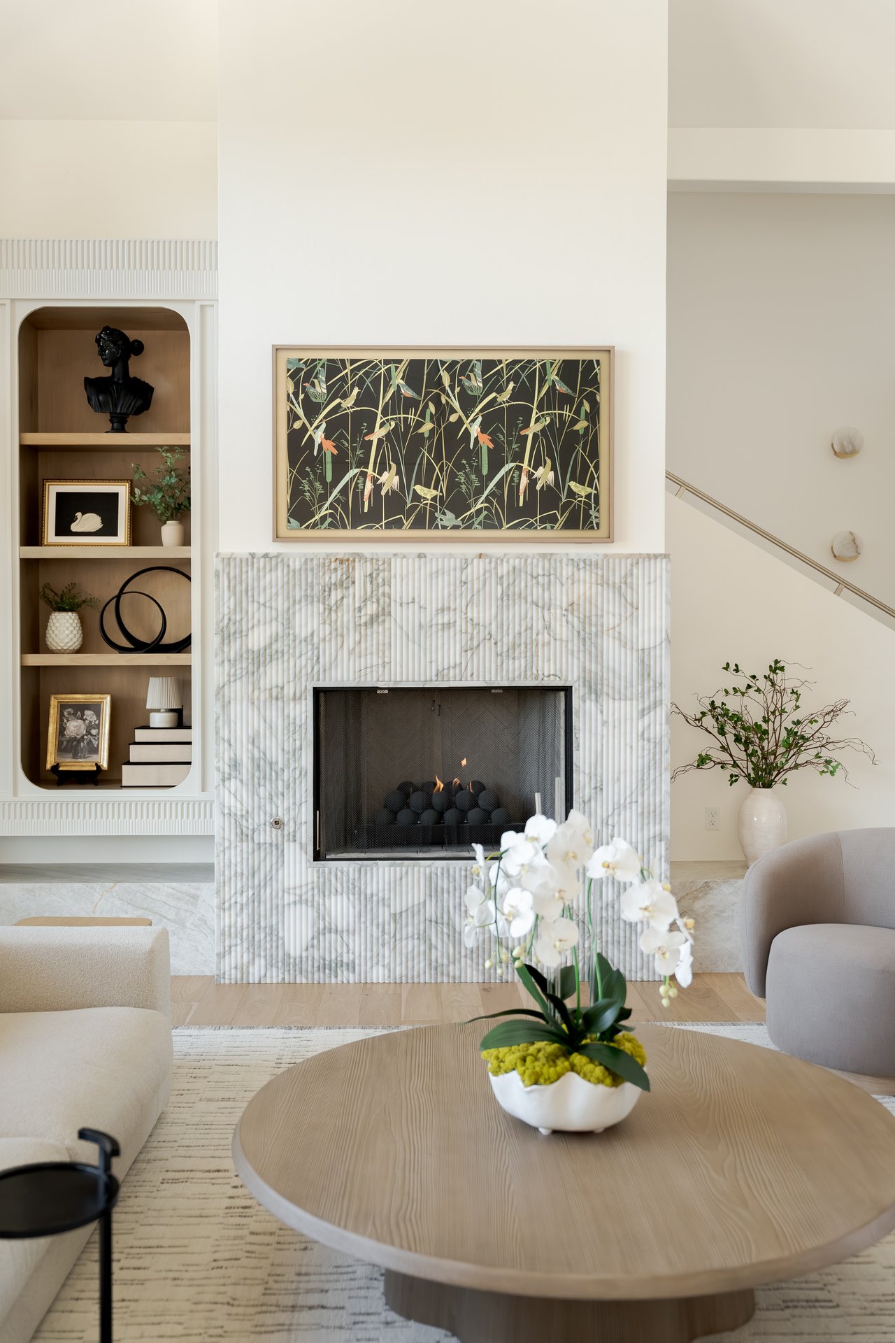 Beautifully staged living room in an Edmond luxury home featuring cozy fall décor, soft lighting, and open-concept design ideal for holiday entertaining.