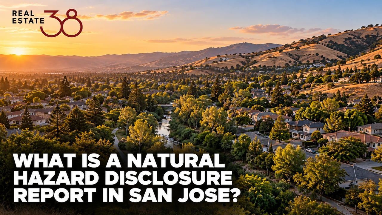 Aerial view of San Jose homes spanning creekside flats to hillside terrain at dusk.