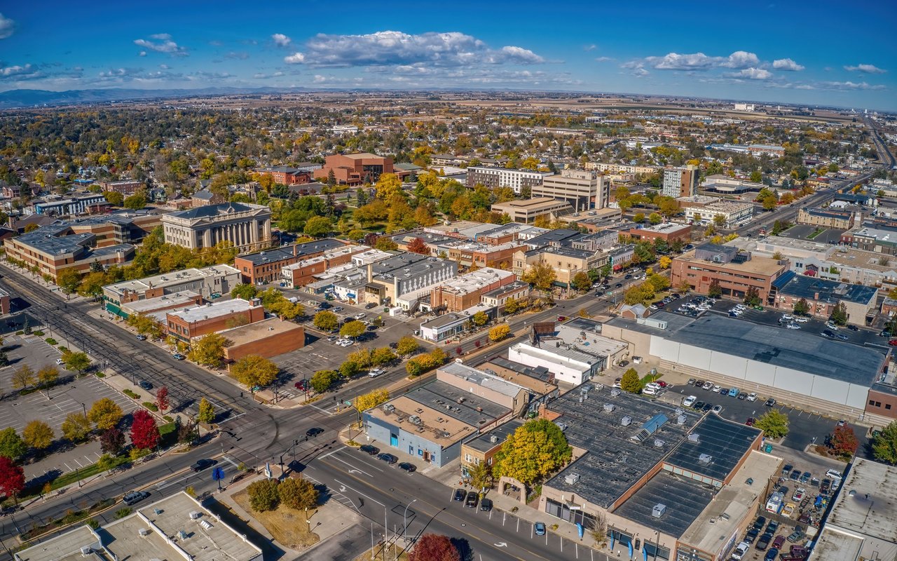 Aerial panorama of downtown Greeley, with autumn-colored trees and the plains beyond.