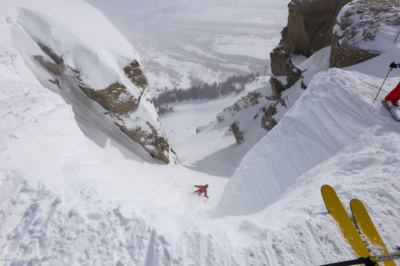 Snow-covered mountains in the Tetons with backcountry skiers on a scenic route, showcasing the adventurous lifestyle near Jackson Hole homes for sale.