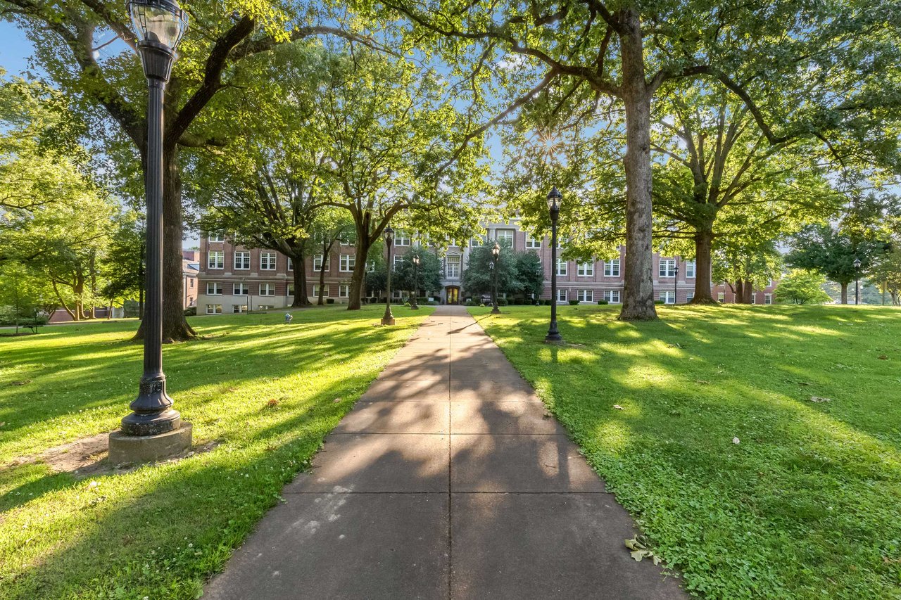 green lawn and building at University of Memphis campus