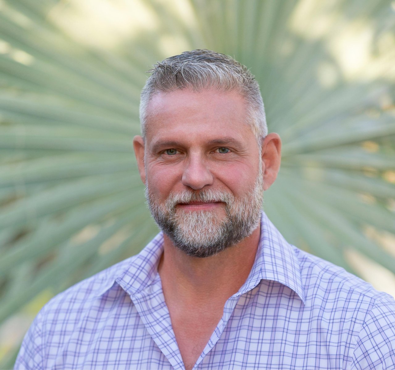 John LePage, a silver-haired man with a beard wearing a checked shirt.