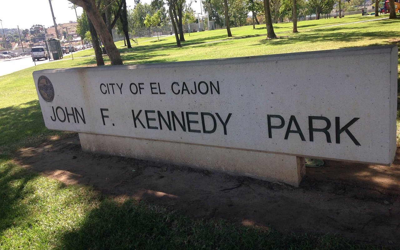 John F. Kennedy Park entrance sign, lawn and mature trees in El Cajon