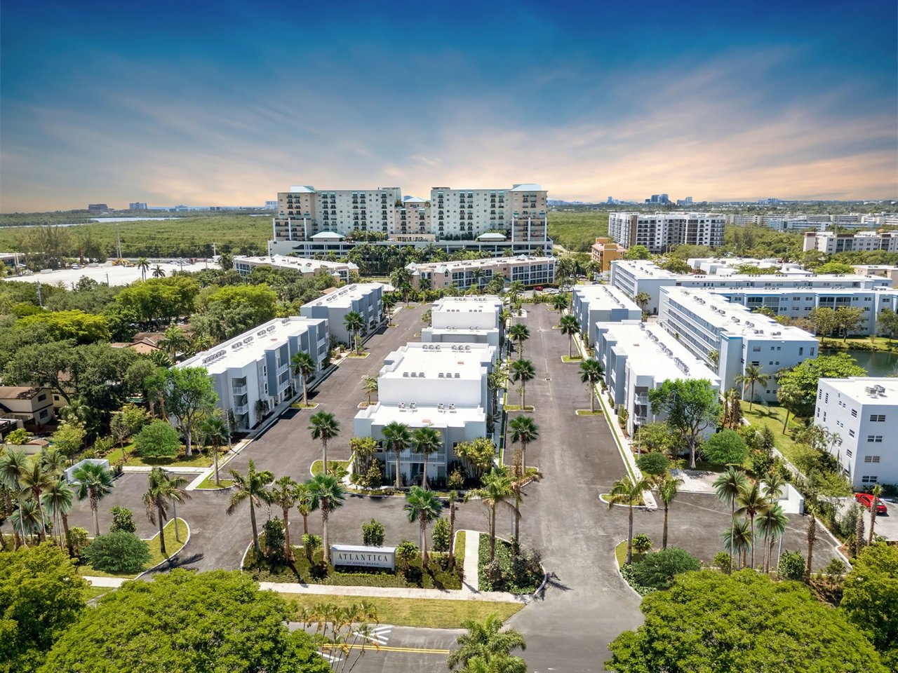 Aerial view of Atlantica at Dania Beach, with palm-lined roads and residential buildings.