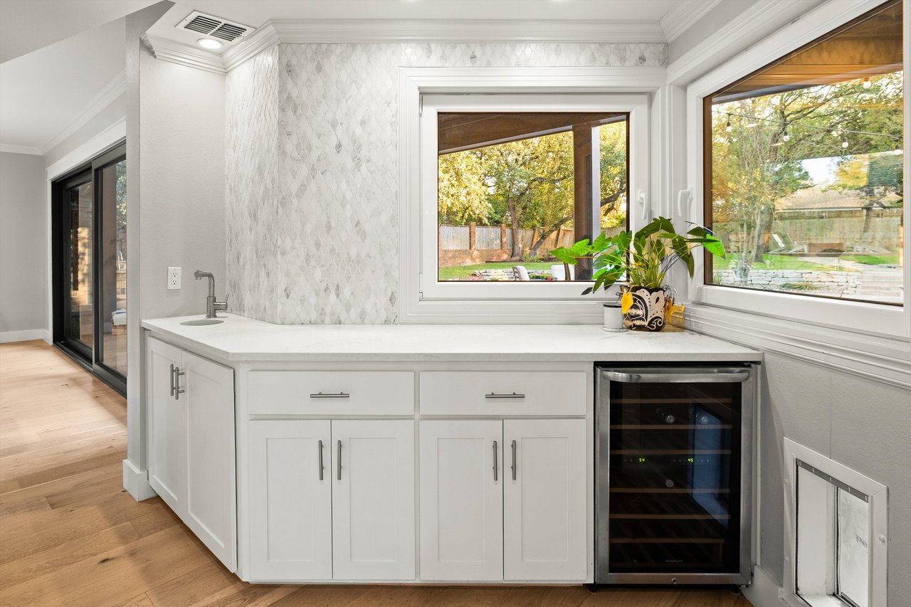 Butler's pantry with wine fridge and pass through windows