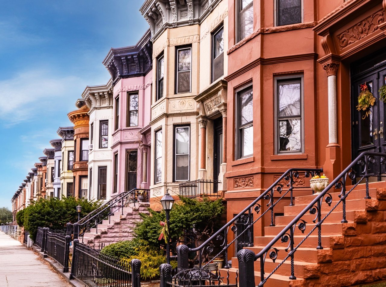 Park Slope Brooklyn brownstone row houses with historic architecture and tree-lined sidewalks.