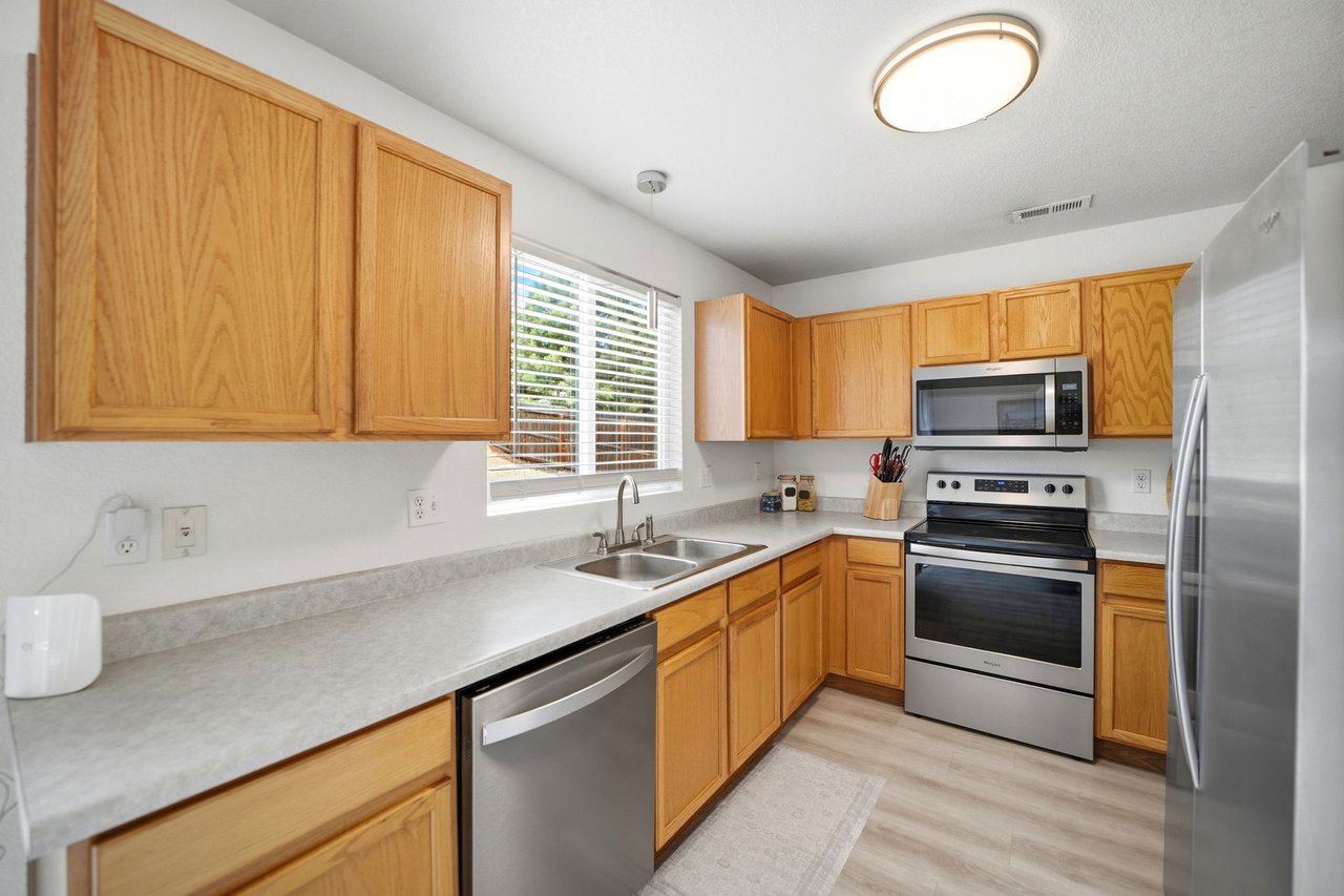 Kitchen with oak cabinets, stainless steel appliances, and pantry