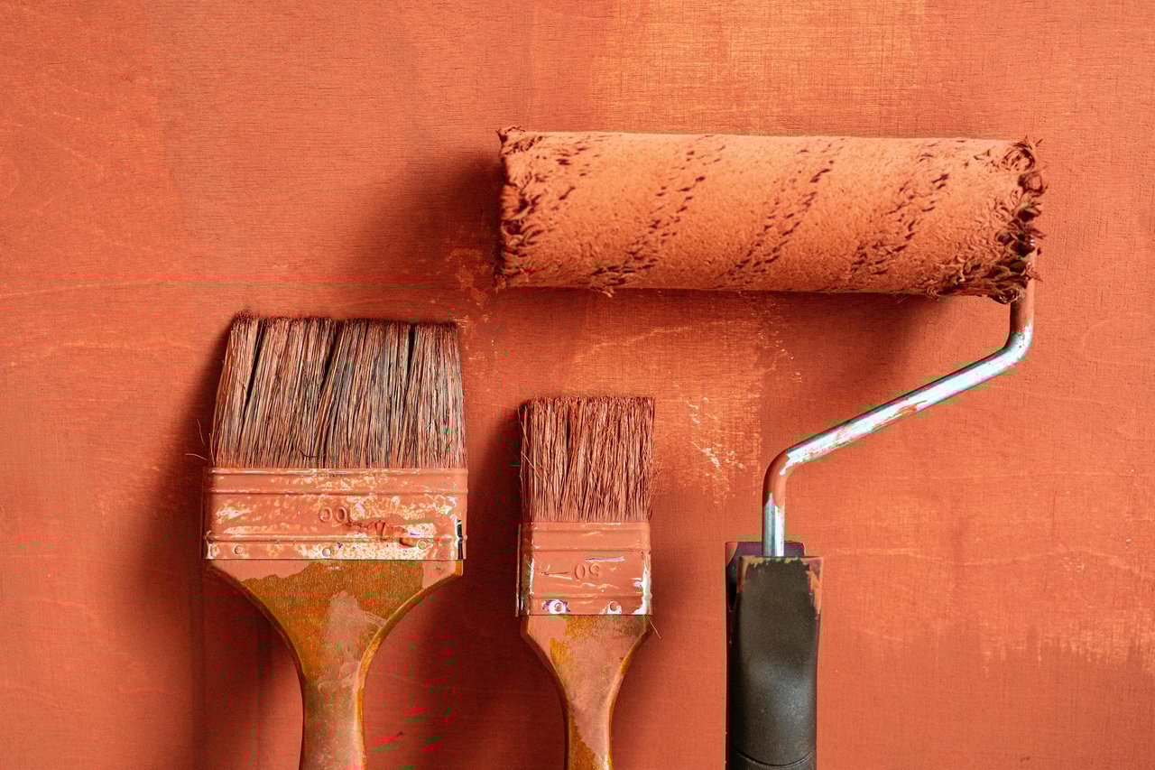 paint brushes covered in red paint
