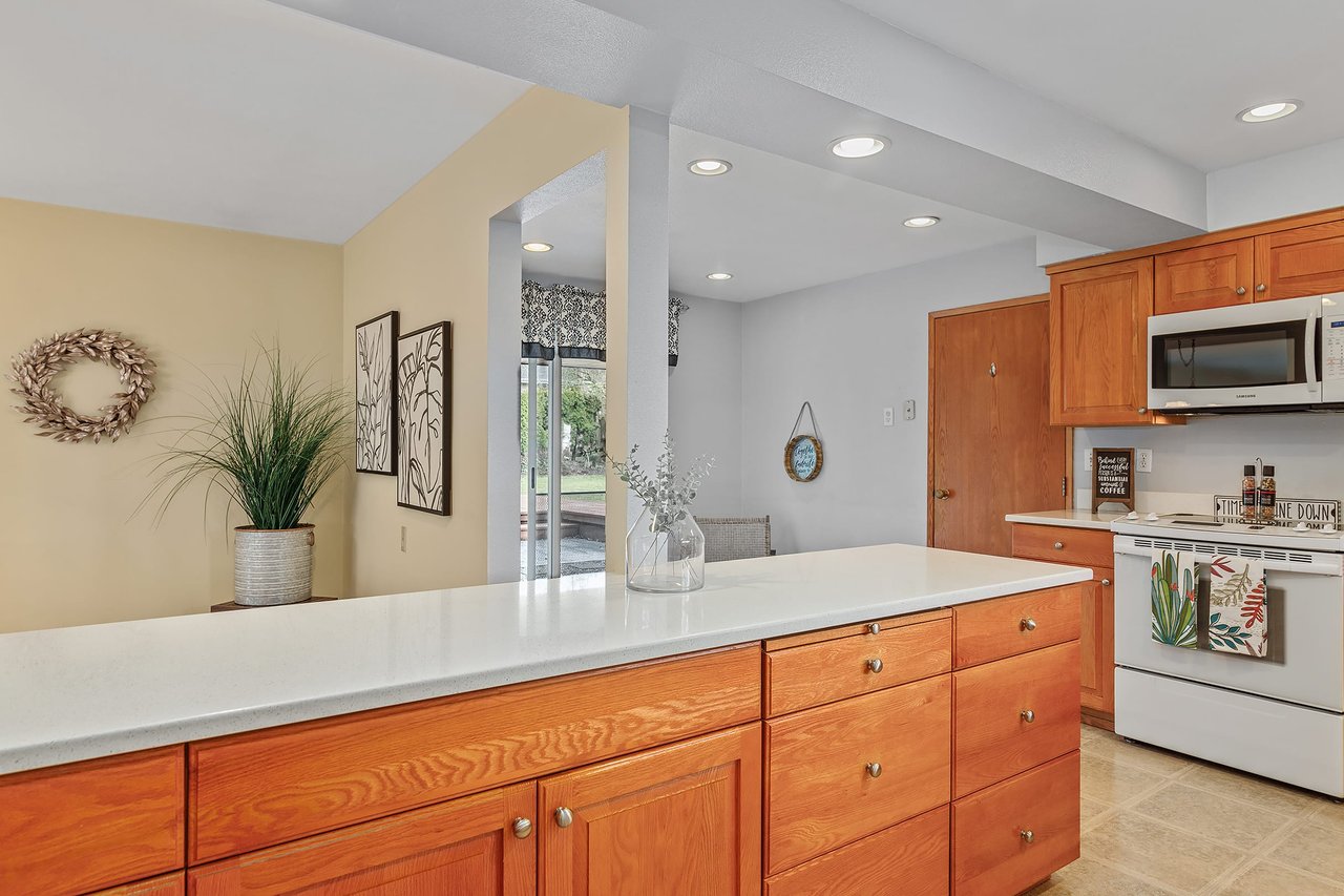 Enjoy versatile dining options with an informal dining room complementing the formal dining space, both adorned with French doors that open gracefully to the backyard.