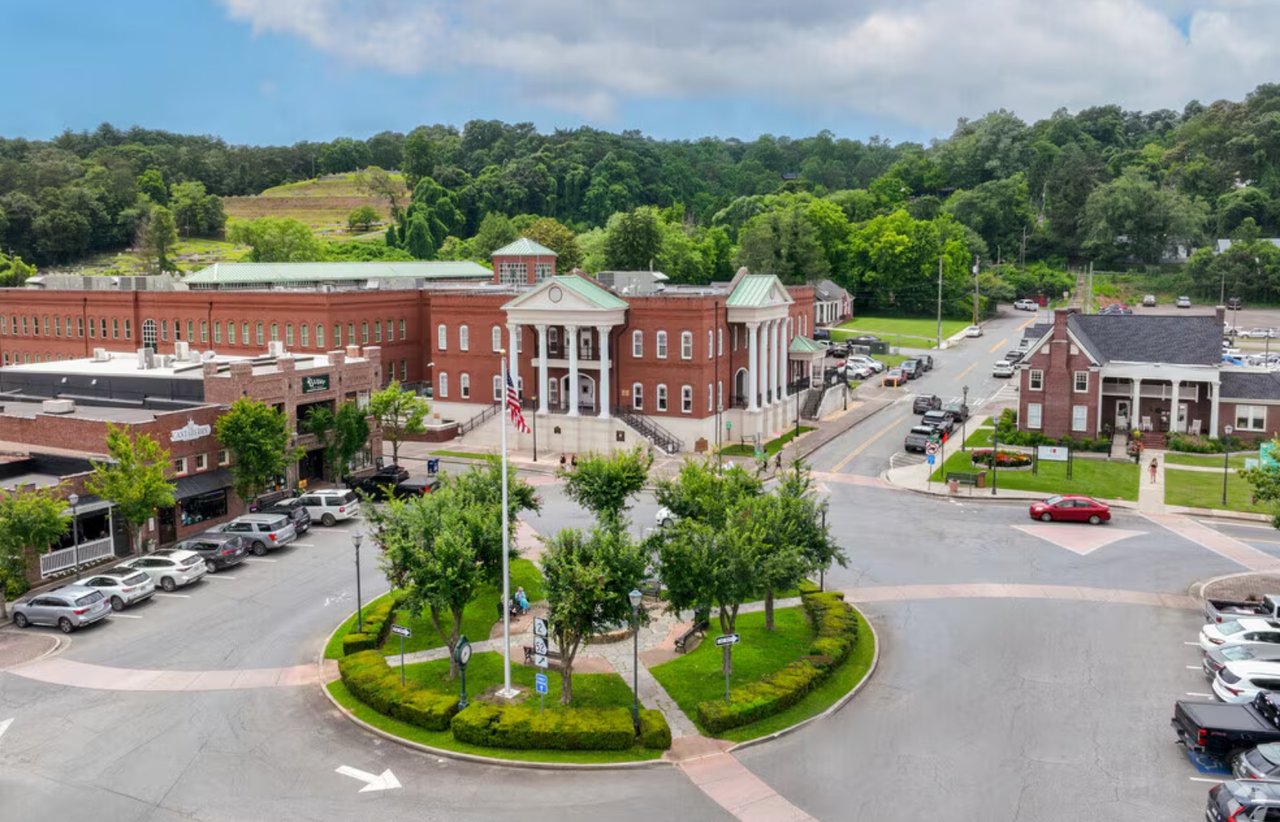 Downtown Ellijay, Georgia, with a red-brick civic building and landscaped traffic circle.