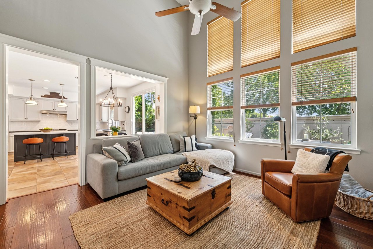 Large gathering space with open floor plan, hardwood flooring, and flexible entertaining opportunities.