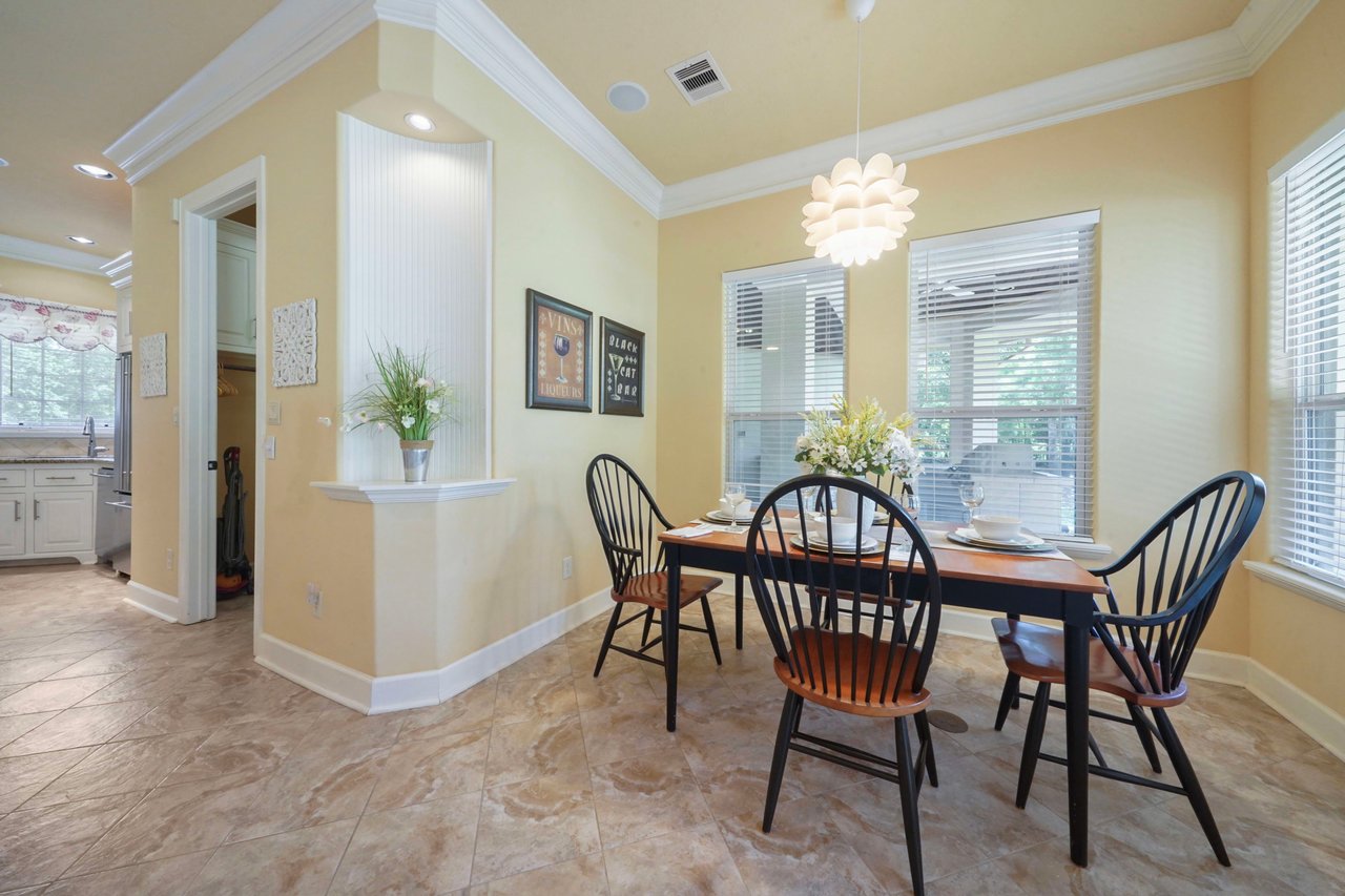 The breakfast area is a cozy nook off the kitchen. The door leads to the laundry, second half-bath, door to 3 car garage, and outside kitchen area.